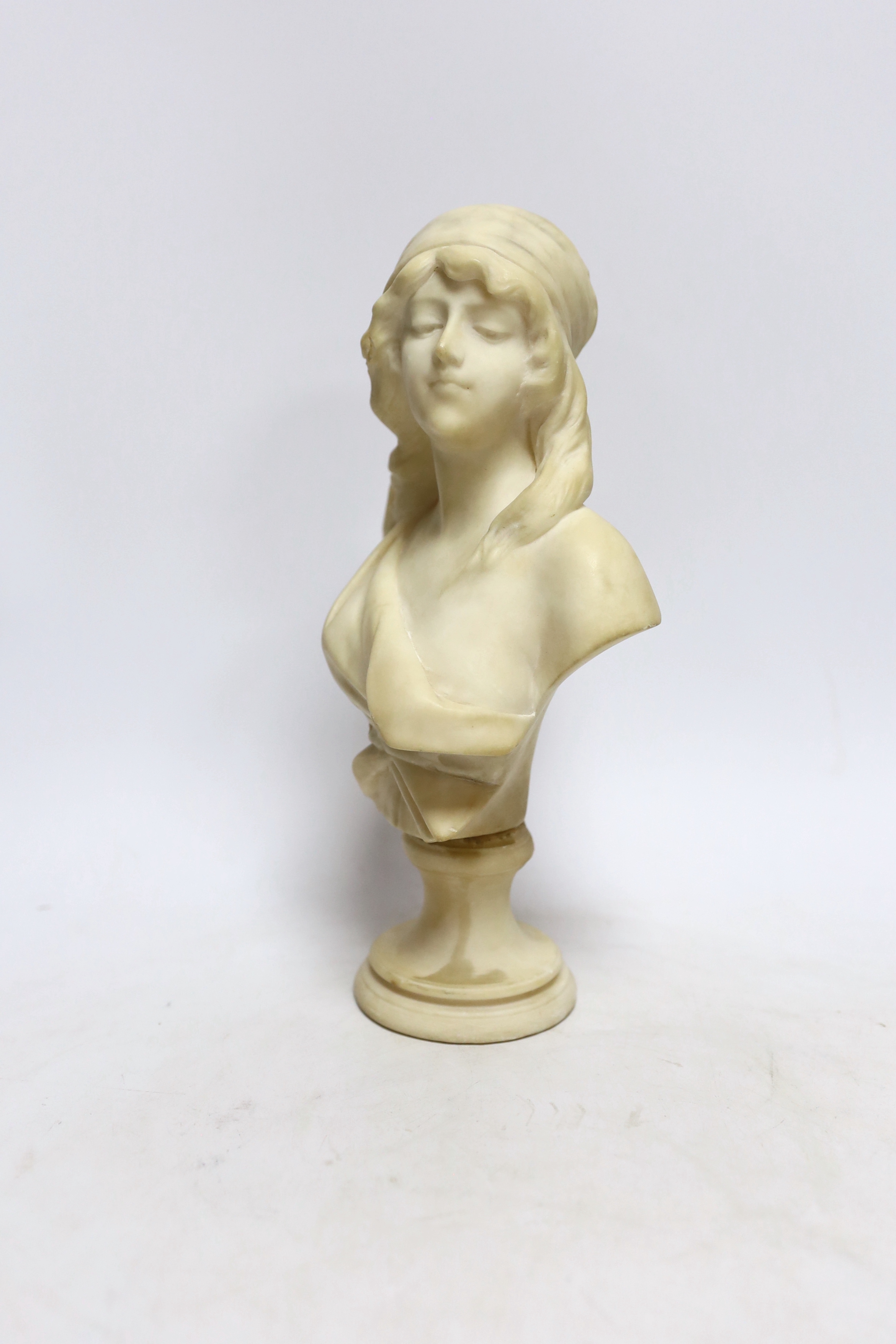 A small alabaster female bust signed H. Cipriani, 26.5cm high
